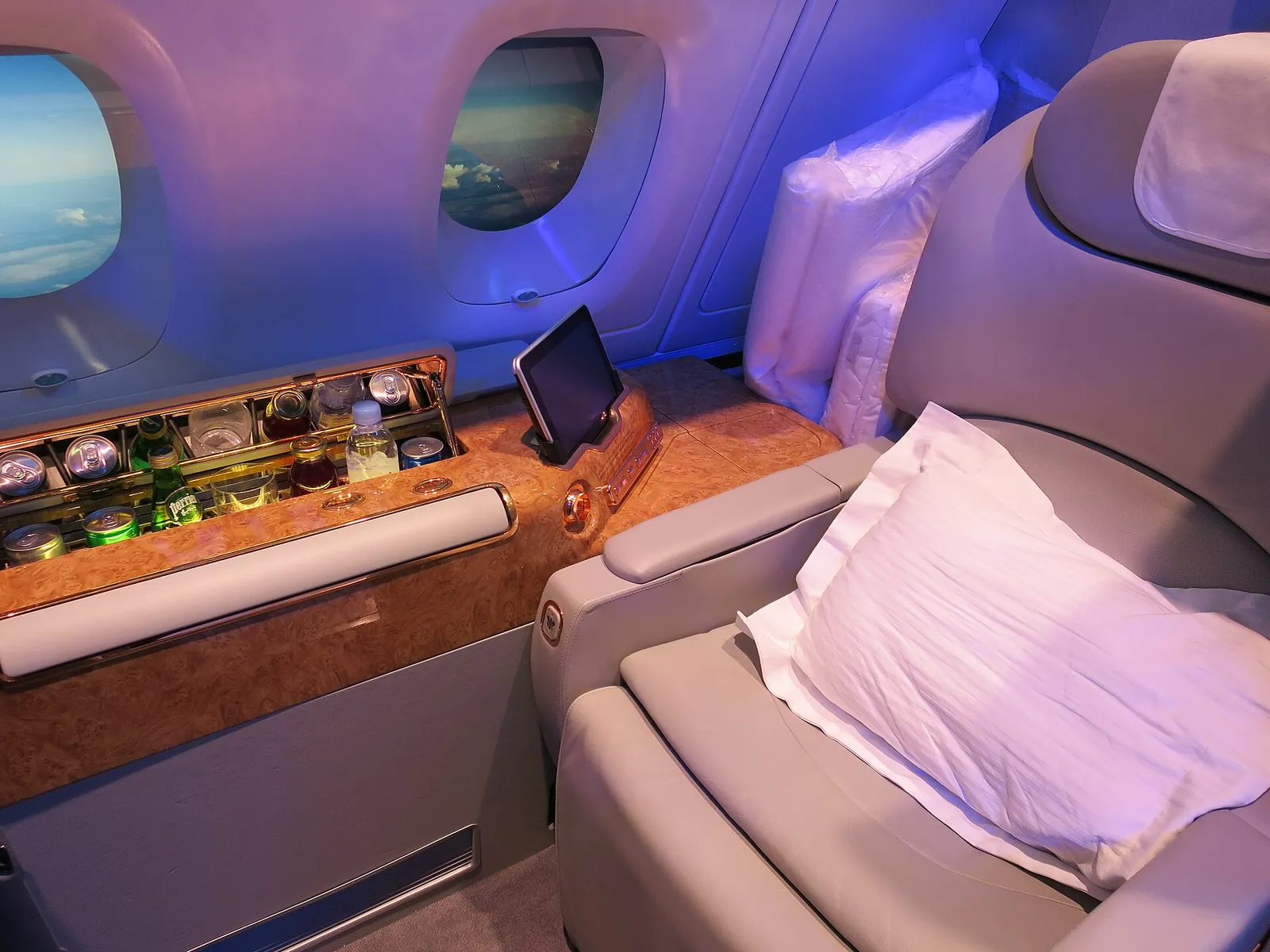 Suíte da primeira classe da Emirates no Airbus A380, com poltrona-cama e minibar